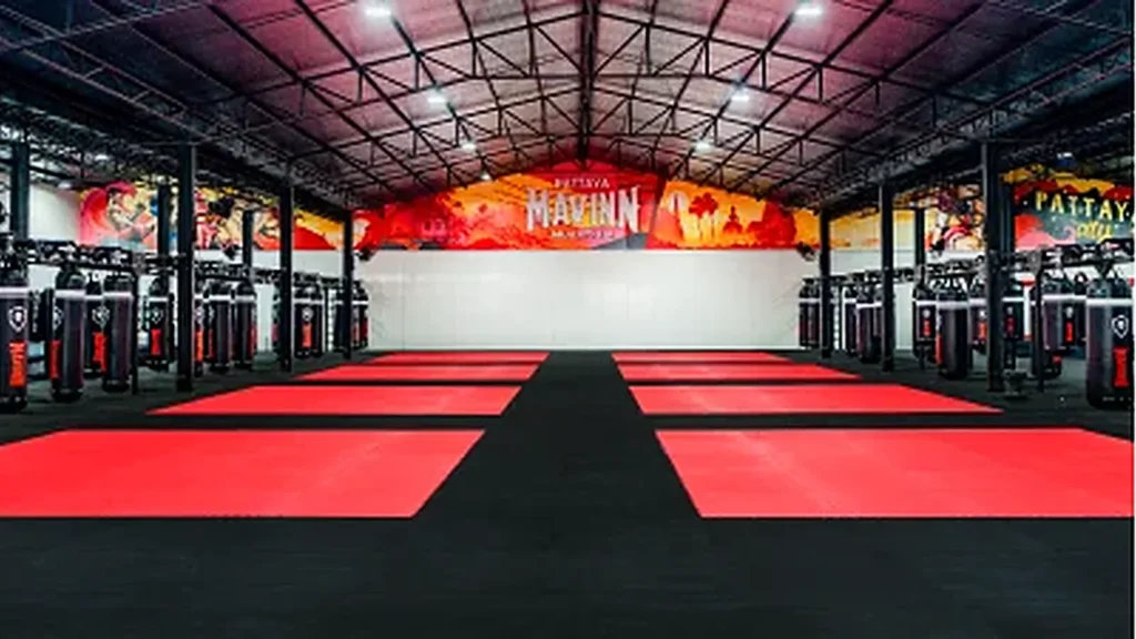 Gym Training floor at the MAVINN Muay Thai Pattaya gym with the ring and a row of heavy bags