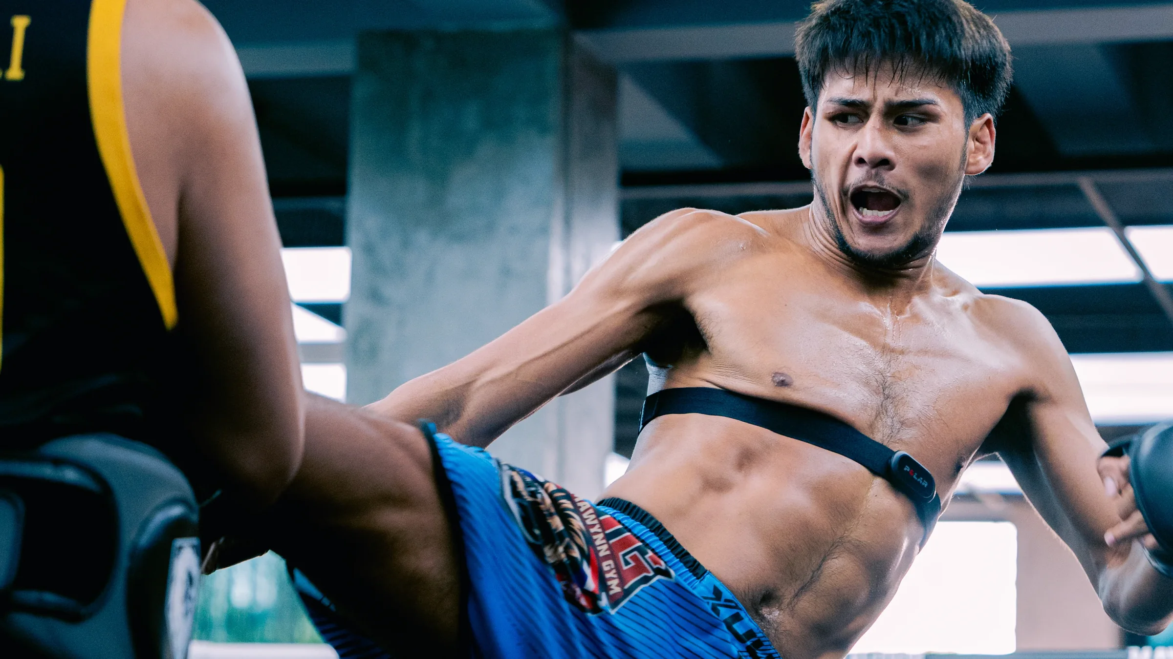 MAVINN fighter launching a jumping kick inside the ring