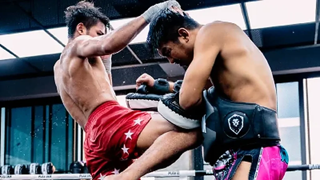 About Fighter landing a kick on Thai pads during a MAVINN training round