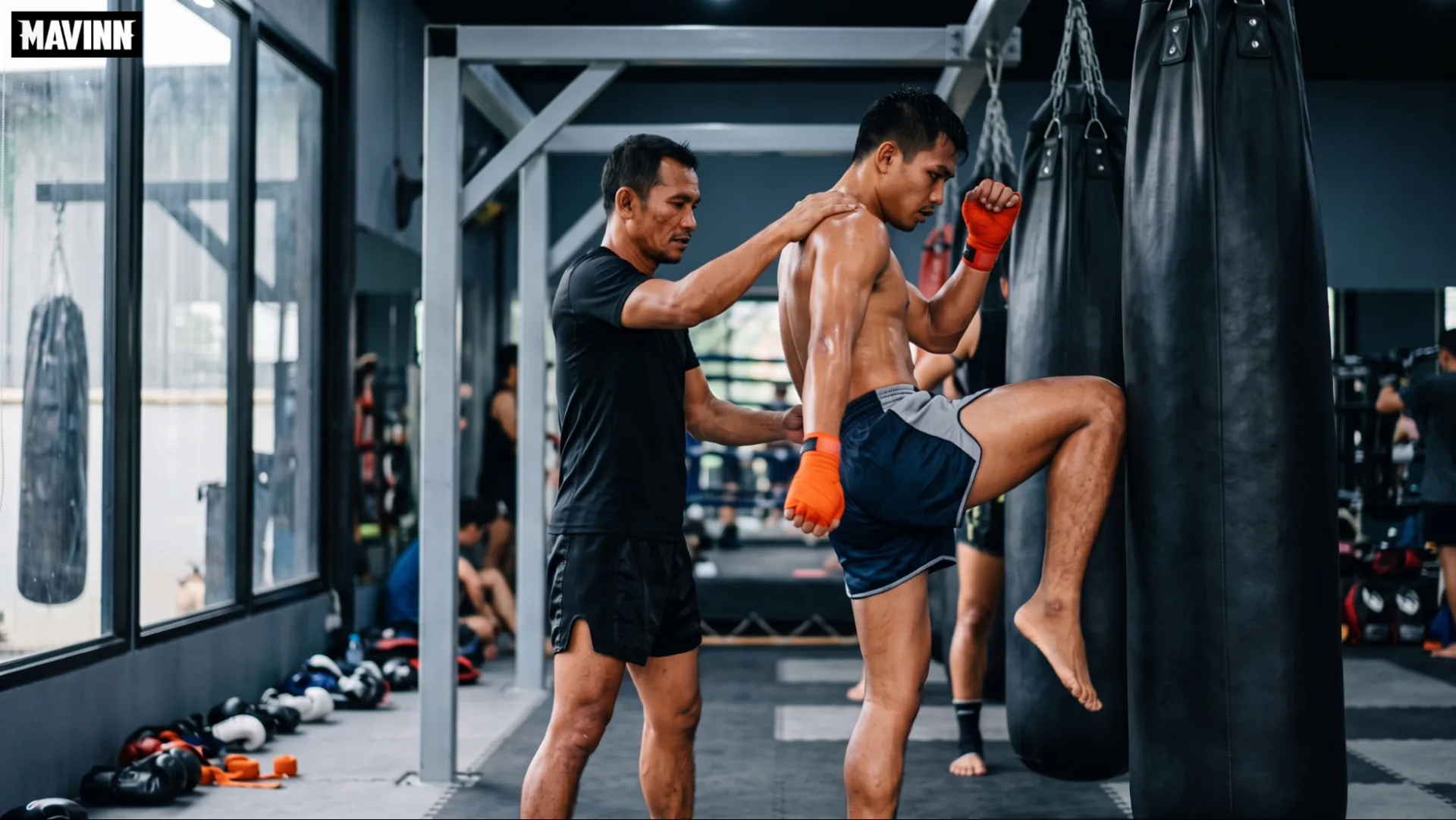 Trainer coaching a student through muay thai knee strikes on the heavy bag