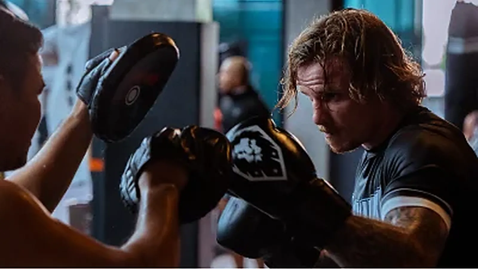 International student working the mitts with a MAVINN trainer