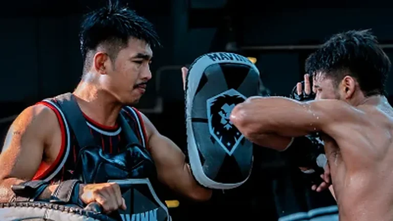 Home Student punching into the round shield held by a MAVINN trainer