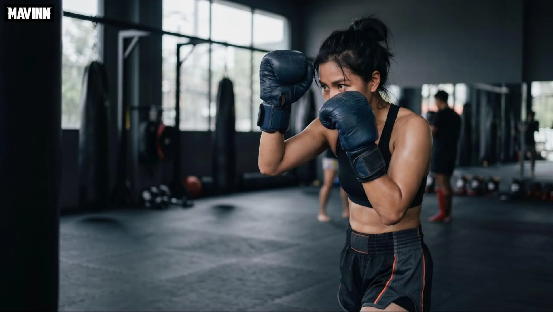 Woman holding a fighting guard while training Muay Thai for self defense at the gym