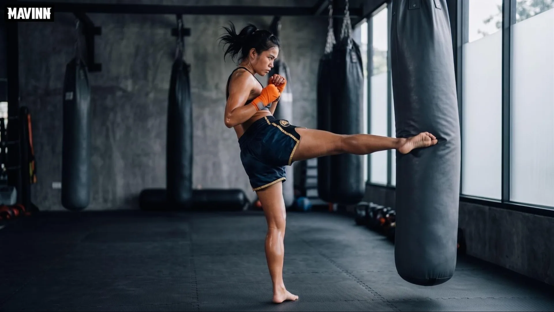 Woman landing a high roundhouse kick on the heavy bag