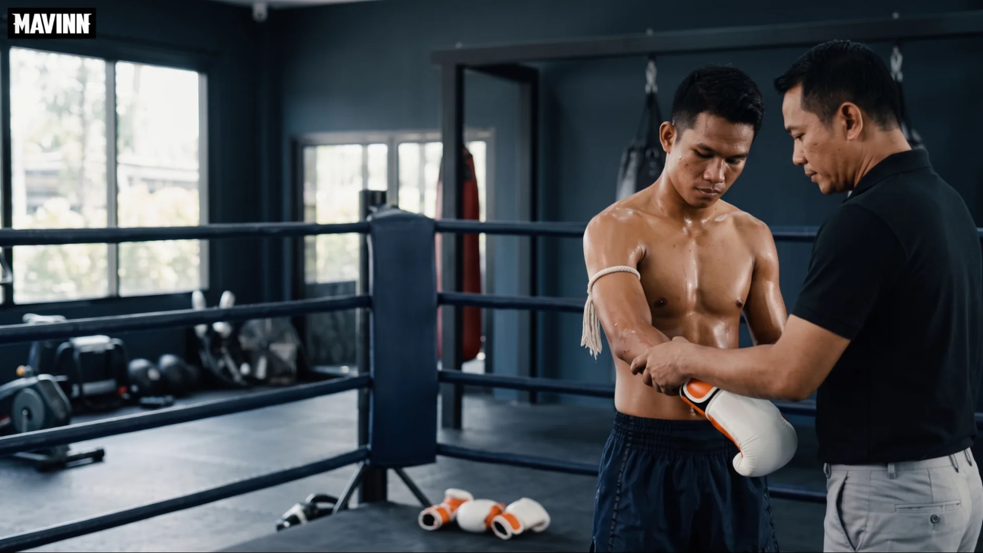 Coach helping a fighter put on his gloves before stepping into the ring