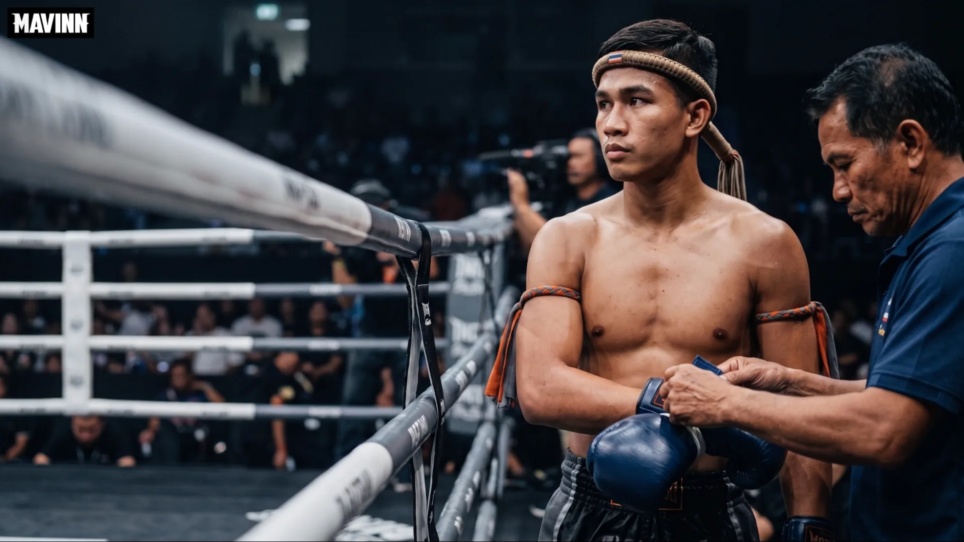 Official fitting gloves on a fighter wearing a mongkhon before the bout begins