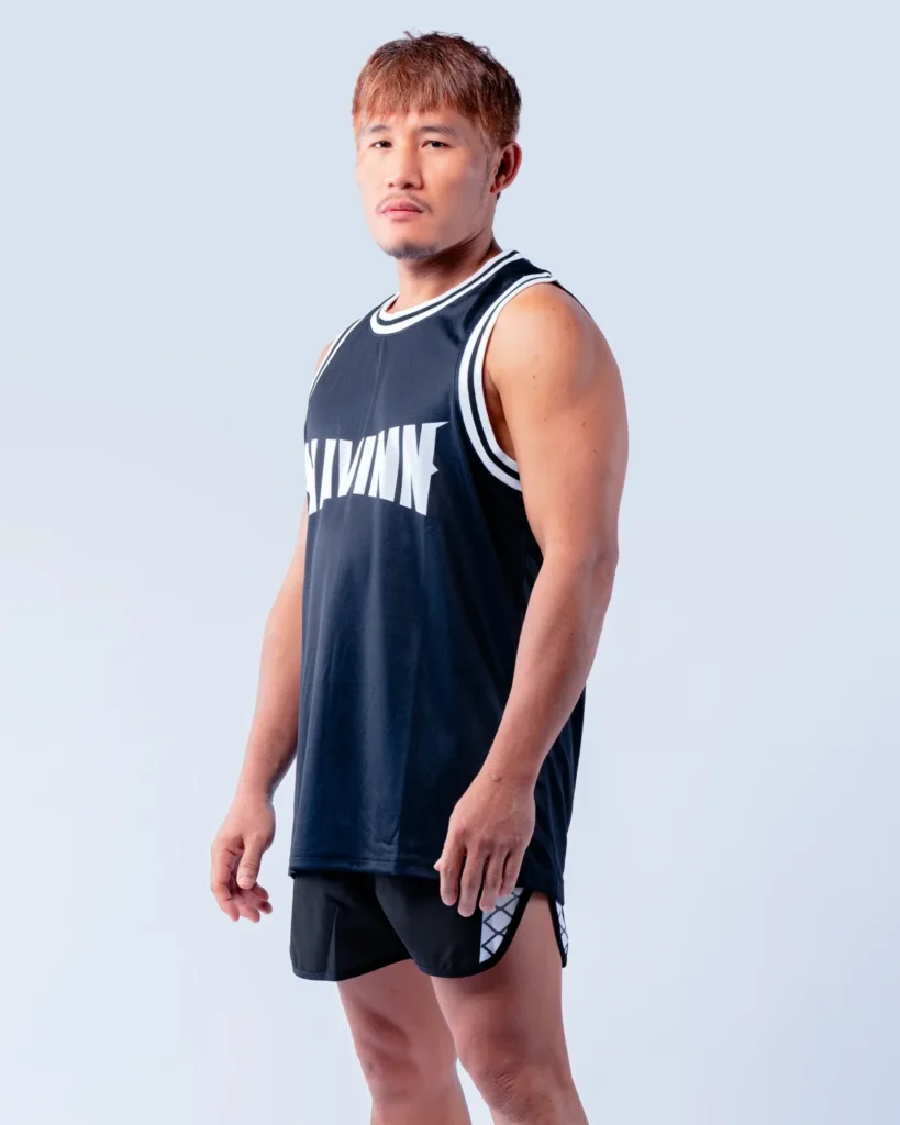 Arkom, member of the MAVINN coaching team, in team vest and training shorts