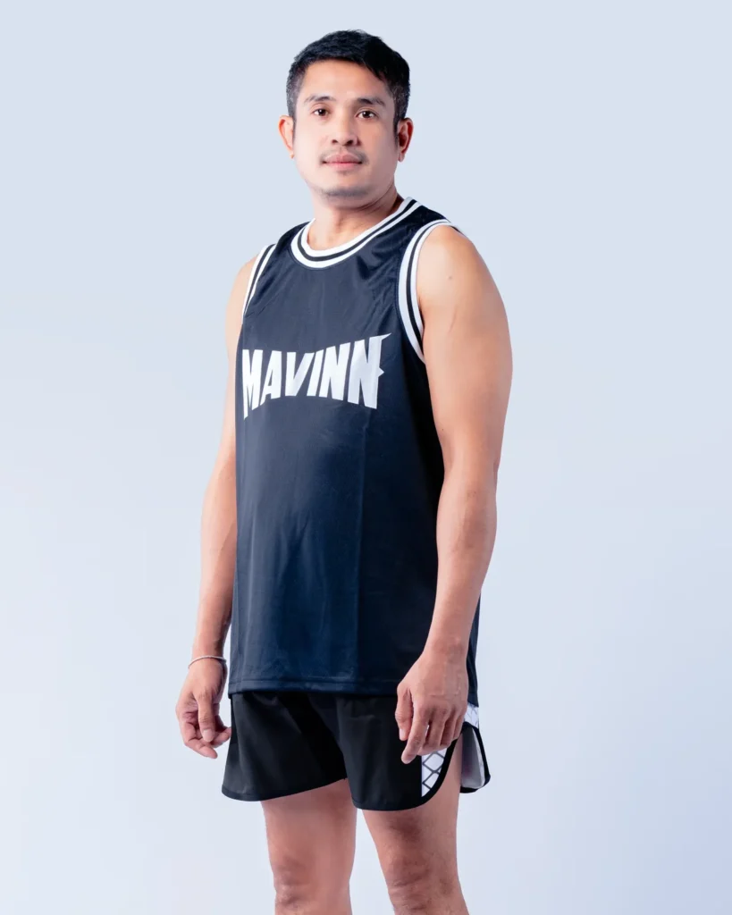 Lek, member of the MAVINN coaching team, in team vest and training shorts