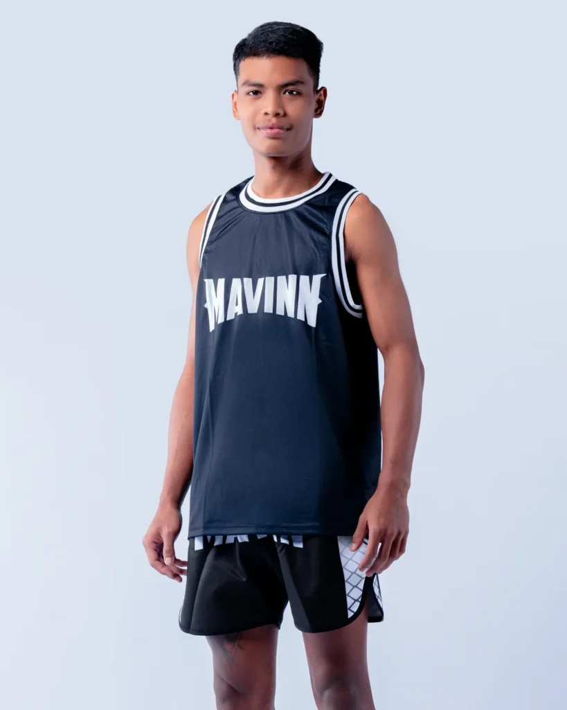 Mangkorn Dam in MAVINN team vest and Muay Thai shorts