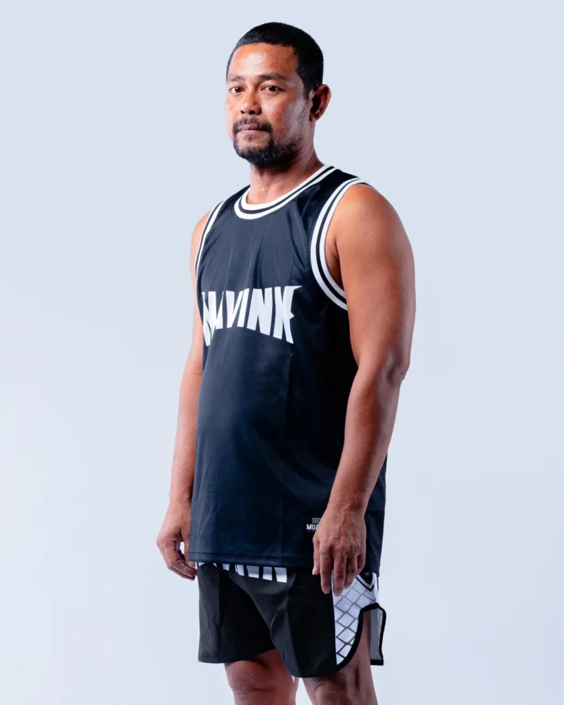 Ood, coach at the MAVINN gym, in team vest and training shorts