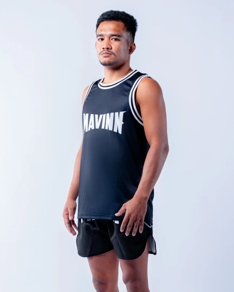 Roichoeng, coach at the MAVINN gym in Bueng Kum, in team vest and training shorts
